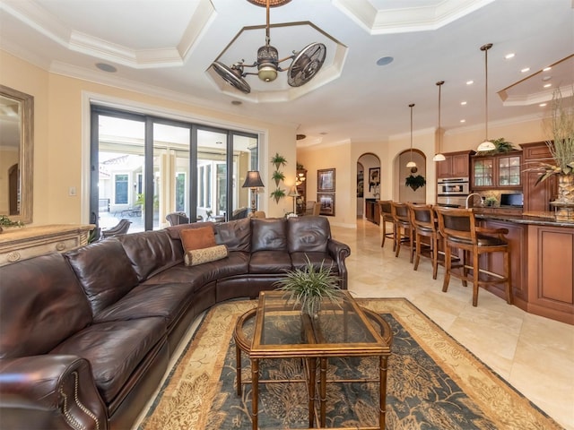 living room with ceiling fan, ornamental molding, and coffered ceiling