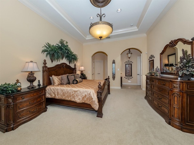 bedroom featuring light carpet, a raised ceiling, and crown molding