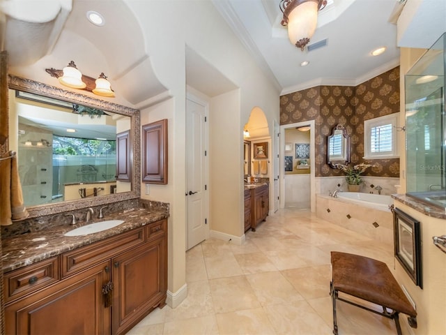 bathroom with plus walk in shower, vanity, and crown molding