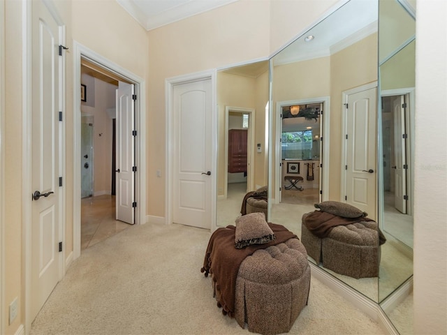 living area with light carpet, a high ceiling, and ornamental molding