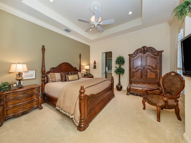 carpeted bedroom featuring a raised ceiling, ceiling fan, and crown molding