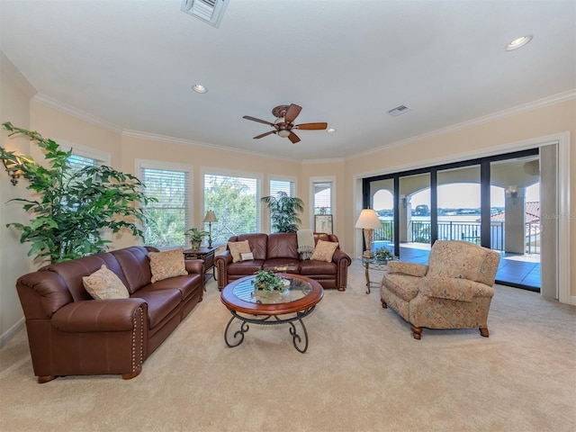 living room featuring light carpet, ceiling fan, and crown molding