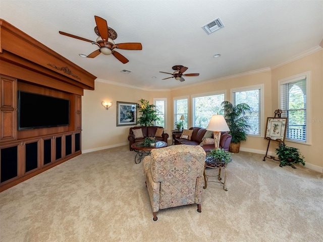 carpeted living room featuring ceiling fan and crown molding