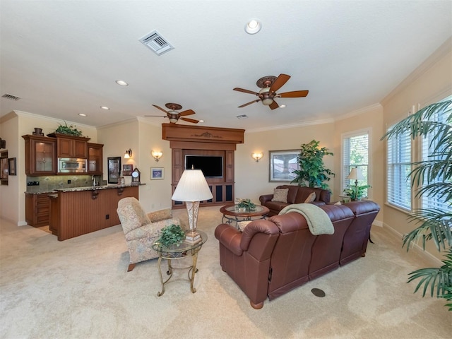 carpeted living room featuring crown molding and ceiling fan