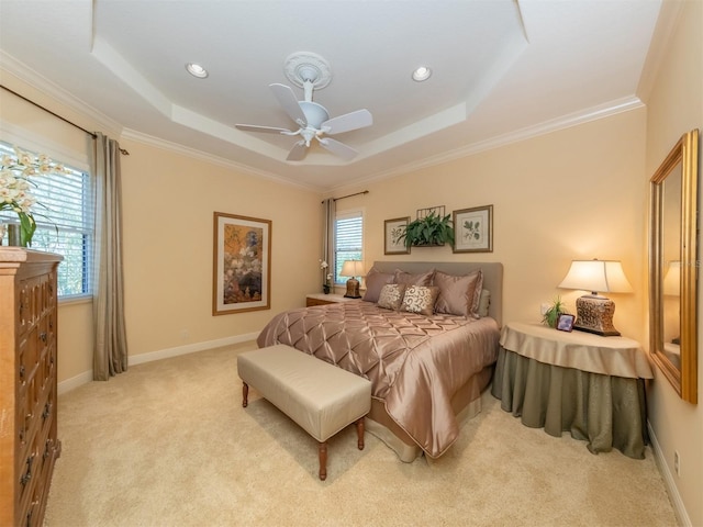 carpeted bedroom featuring multiple windows, a raised ceiling, and ceiling fan