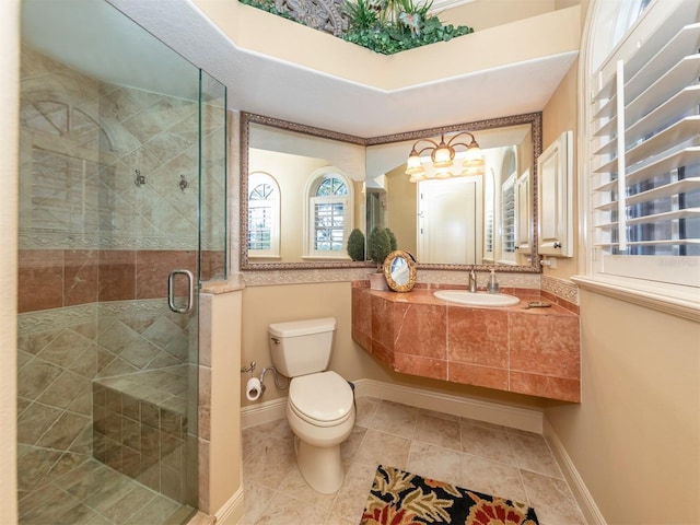 bathroom with tile patterned flooring, toilet, a shower with door, and sink