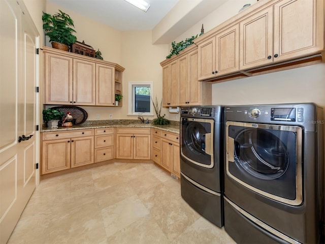 clothes washing area featuring cabinets, separate washer and dryer, and sink