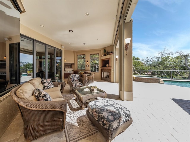 view of patio / terrace featuring outdoor lounge area and a pool with hot tub