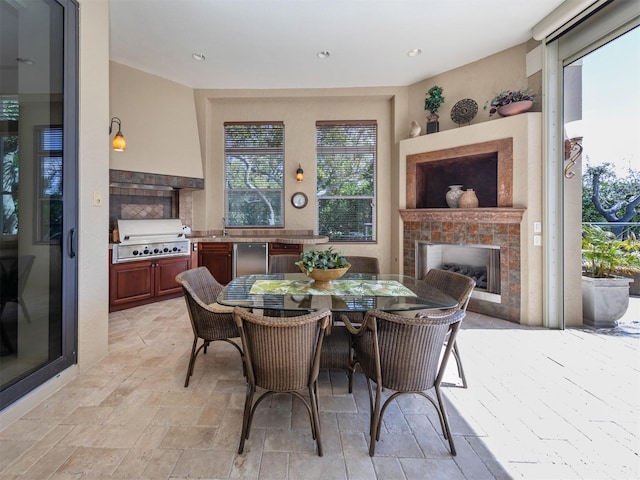 dining space with a tile fireplace