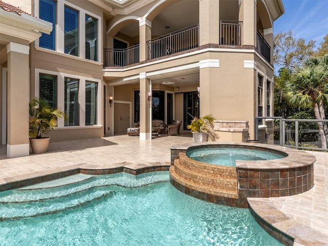 view of swimming pool with a patio area and an in ground hot tub