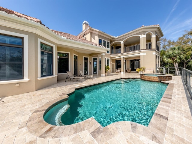 view of pool with an in ground hot tub and a patio