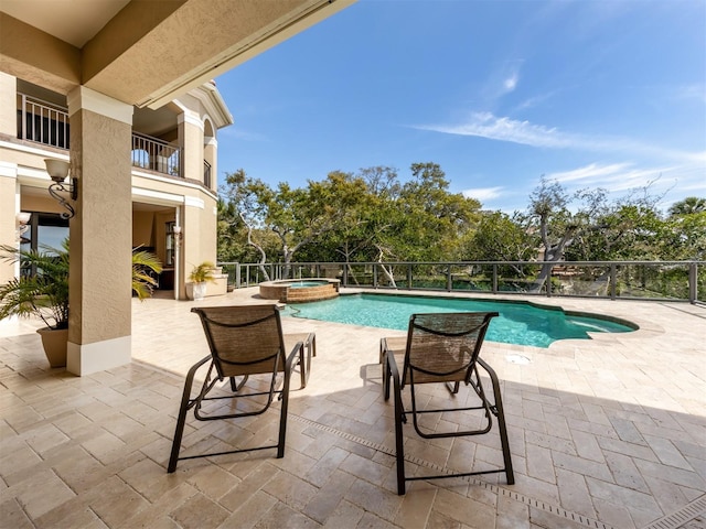 view of swimming pool with an in ground hot tub and a patio