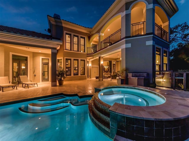 view of pool featuring an in ground hot tub, french doors, and a patio