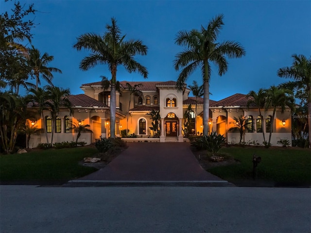 mediterranean / spanish home with a front yard