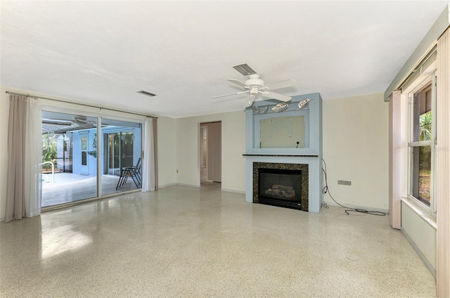 unfurnished living room featuring ceiling fan