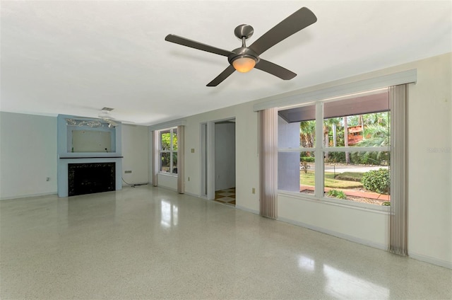 unfurnished living room with ceiling fan