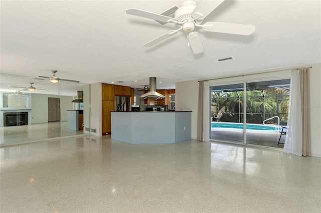 unfurnished living room featuring ceiling fan