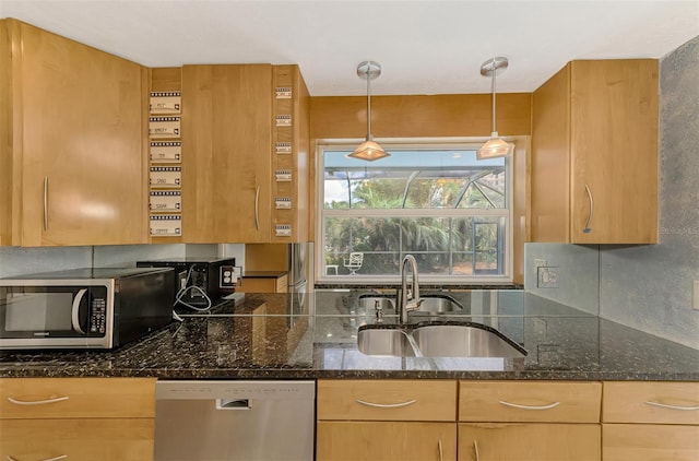 kitchen with sink, light brown cabinets, stainless steel appliances, dark stone counters, and pendant lighting