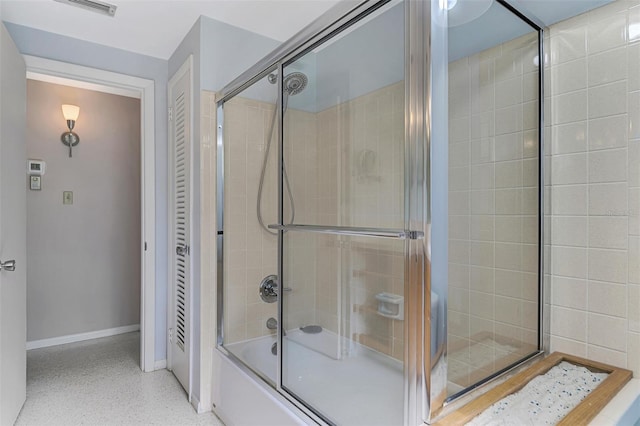 bathroom featuring bath / shower combo with glass door