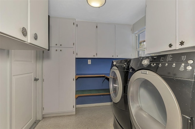 laundry room with cabinets and washing machine and clothes dryer