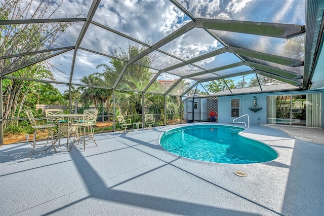 view of swimming pool with a lanai and a patio area