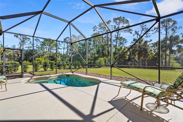 view of pool featuring glass enclosure, a yard, and a patio