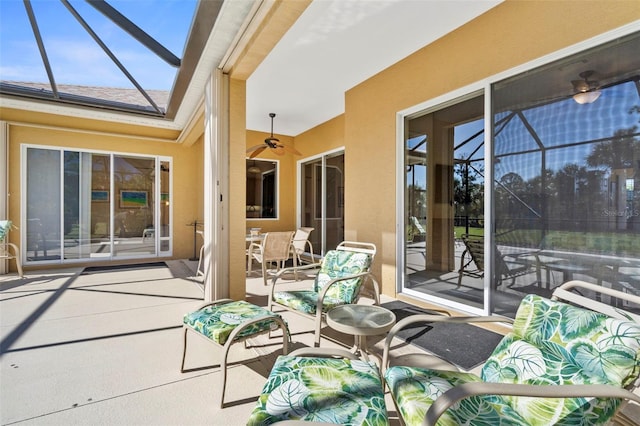 view of patio / terrace featuring a lanai and ceiling fan