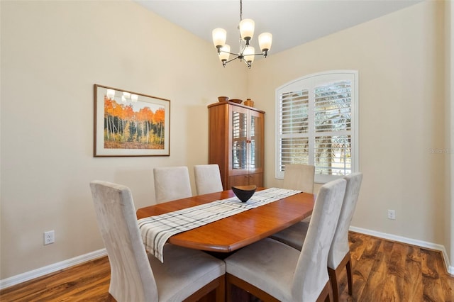 dining space with an inviting chandelier and dark wood-type flooring