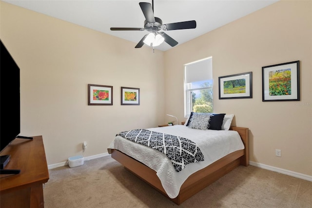 bedroom with light carpet and ceiling fan