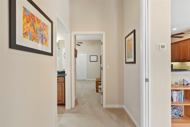 corridor with light colored carpet