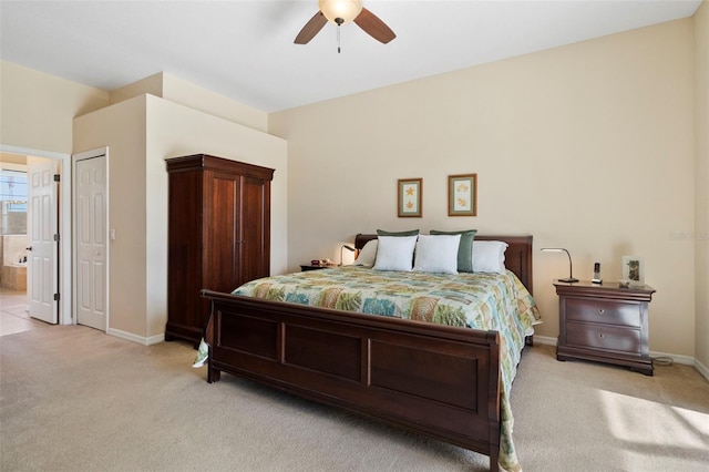 bedroom featuring ensuite bath, ceiling fan, and light carpet