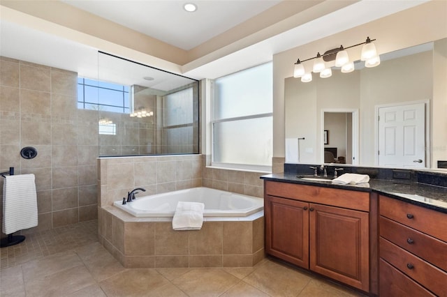 bathroom featuring tile patterned flooring, vanity, and separate shower and tub