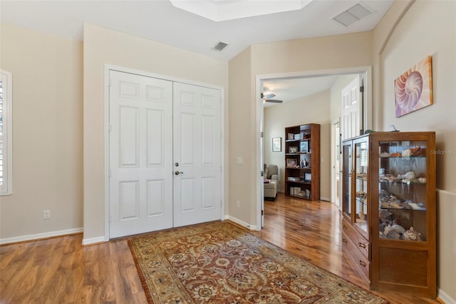 entrance foyer with ceiling fan and wood-type flooring