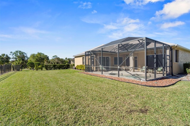 rear view of house with a lanai, a yard, a patio, and a pool