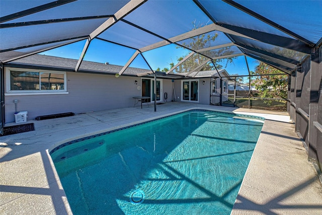 view of pool with a patio and a lanai