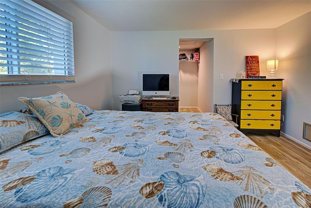 bedroom with wood-type flooring