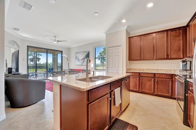 kitchen featuring appliances with stainless steel finishes, ornamental molding, ceiling fan, sink, and a center island with sink