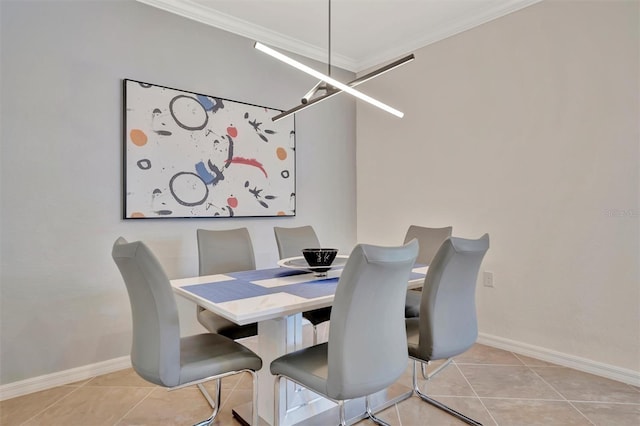 dining area featuring light tile patterned floors, crown molding, and an inviting chandelier