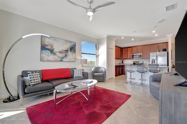 tiled living room with ceiling fan and crown molding