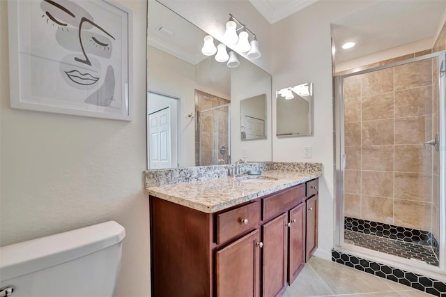 bathroom with tile patterned floors, ornamental molding, vanity, toilet, and a shower with shower door