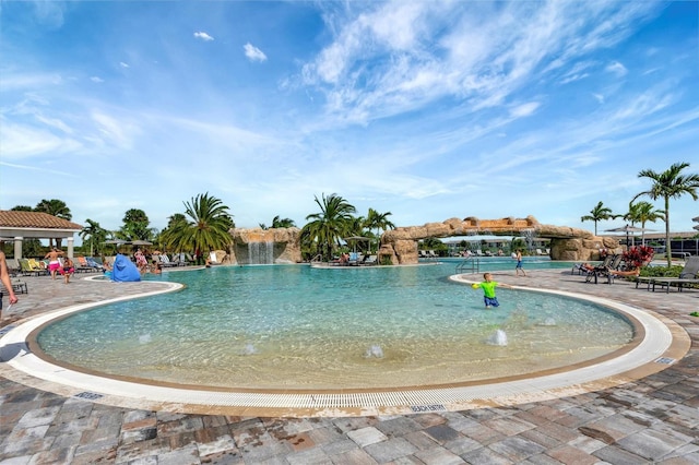 view of pool with pool water feature and a patio area