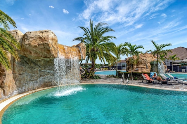 view of swimming pool featuring pool water feature