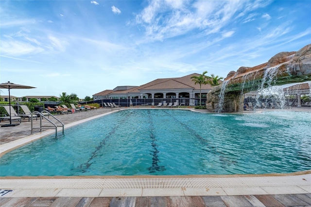 view of pool with pool water feature and a patio