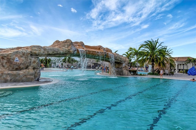 view of swimming pool with pool water feature