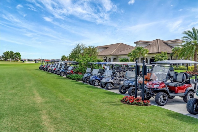 view of parking / parking lot featuring a lawn