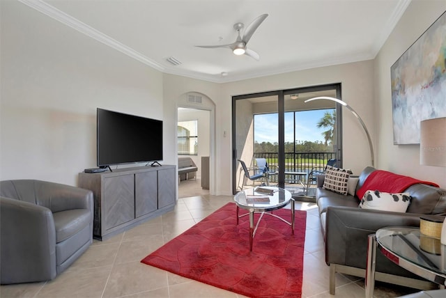 living room featuring ceiling fan, ornamental molding, and light tile patterned flooring