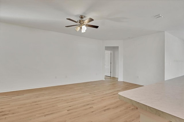 unfurnished room with ceiling fan and light hardwood / wood-style flooring