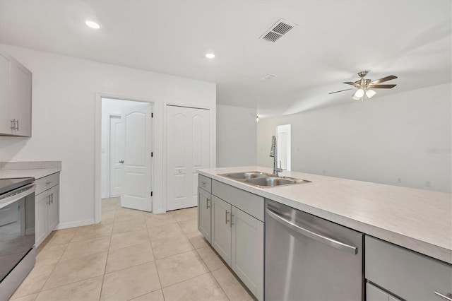 kitchen featuring sink, ceiling fan, light tile patterned floors, gray cabinetry, and appliances with stainless steel finishes