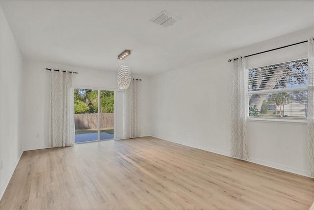 empty room with light hardwood / wood-style flooring