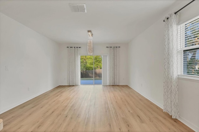 spare room featuring light hardwood / wood-style floors